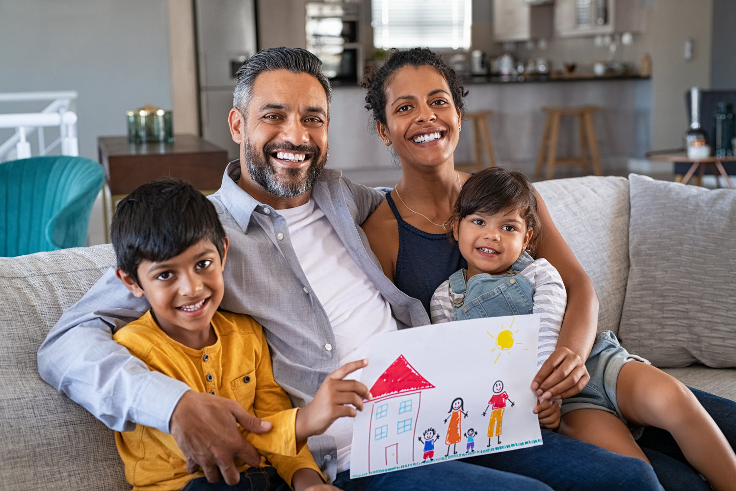 Happy family on sofa showing picture