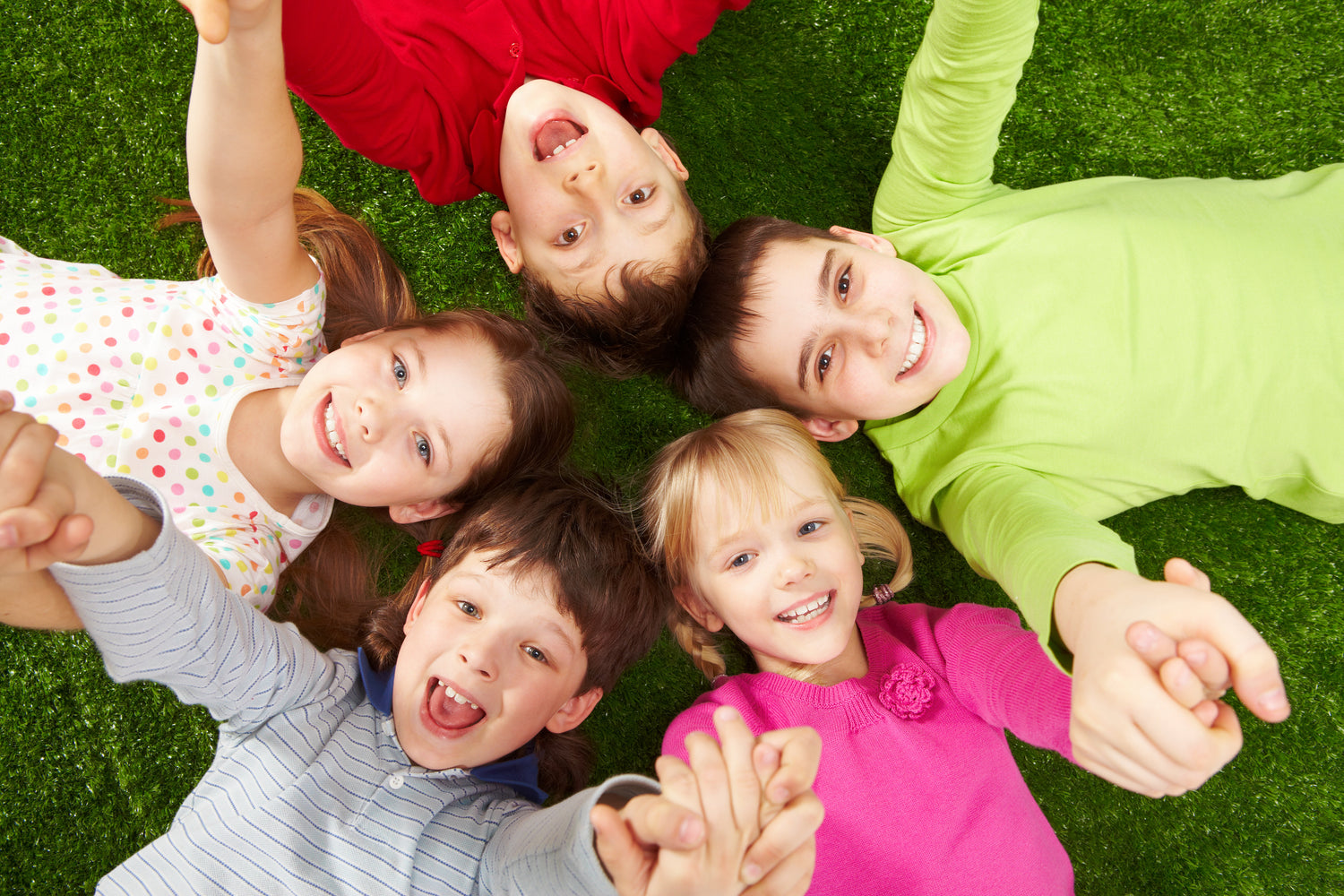 Happy kids huddle (top view) 